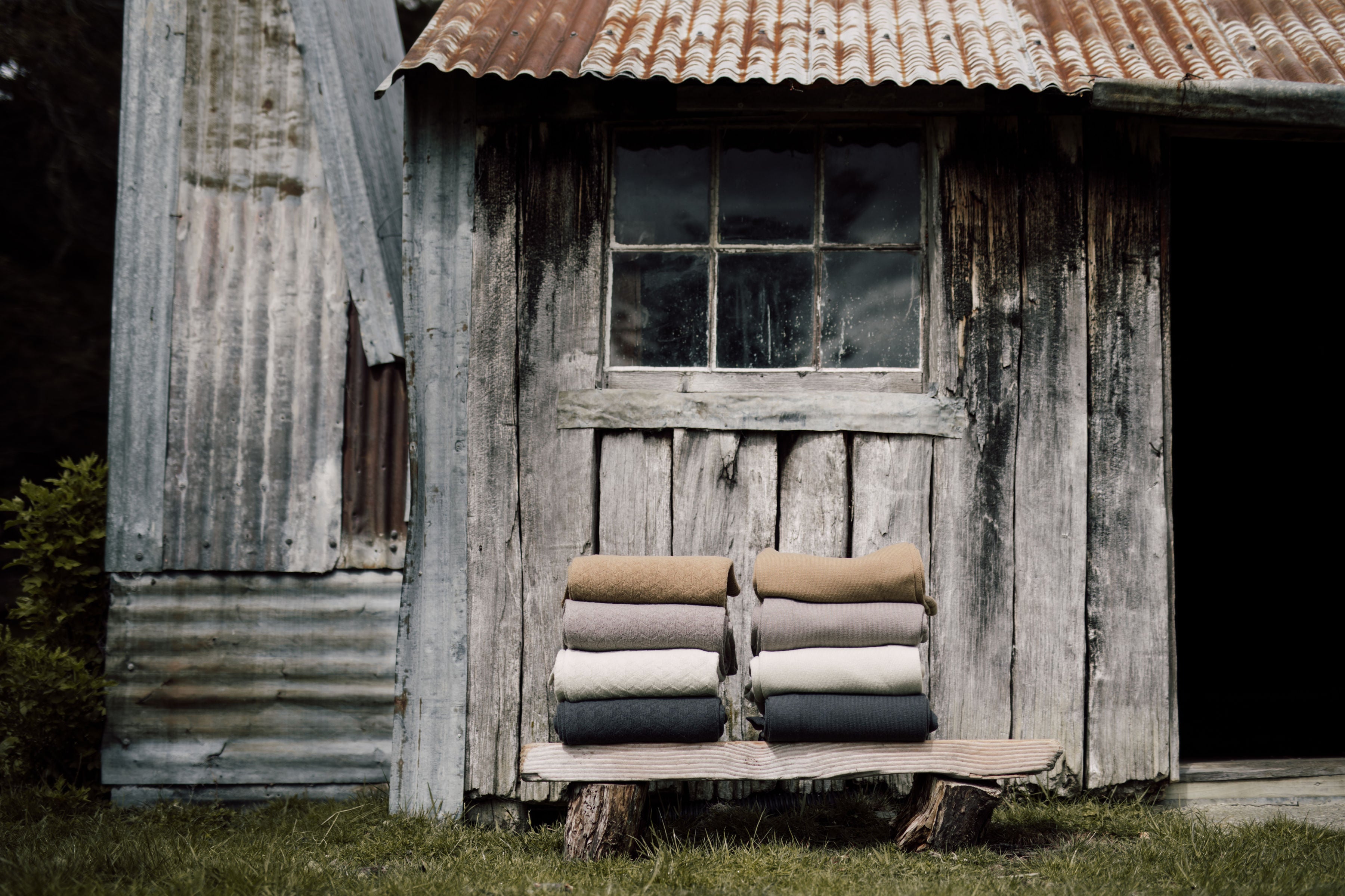 Mount Nicholas Merino throws beautifully sat outside an old farm cottage.